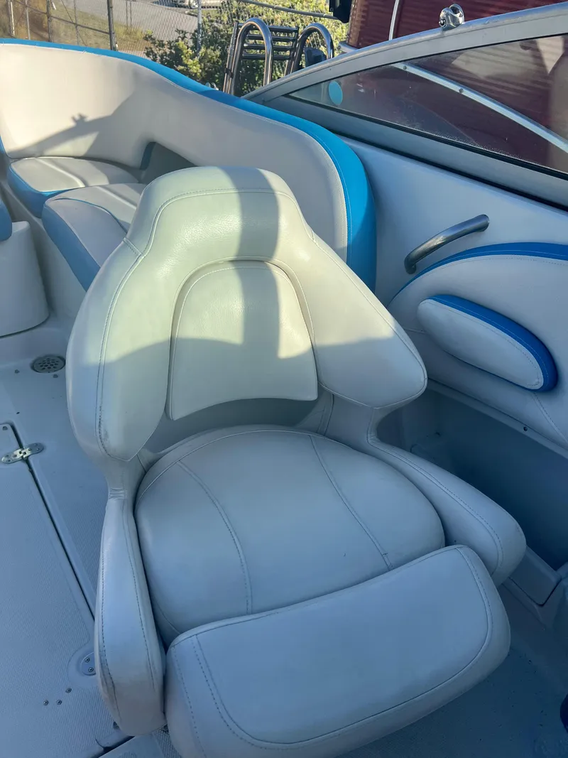 Slide: The Image of Captain's chair in 2018 Crownline Eclipse E21 XS boat, white and blue interior. - 14
