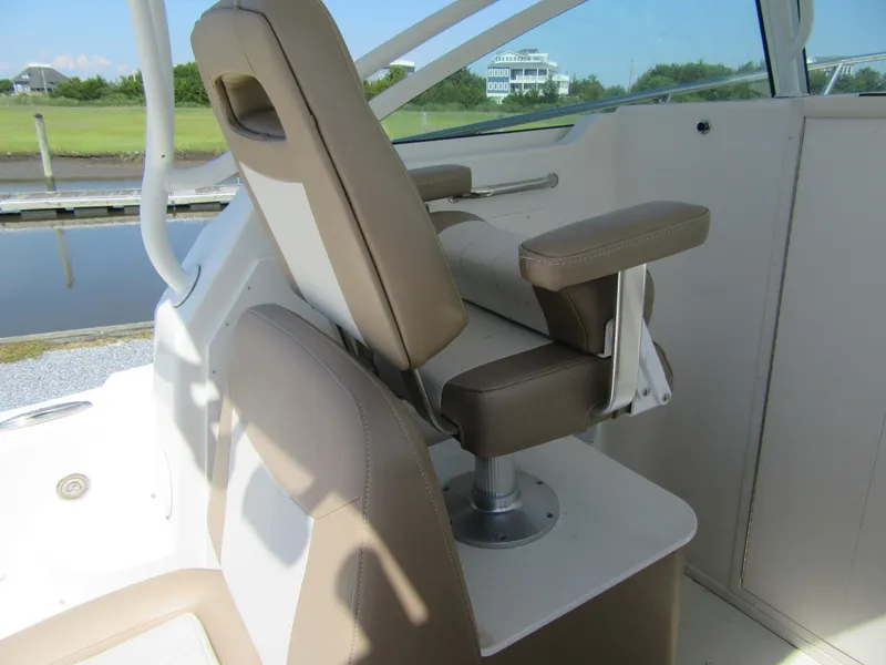 Slide: The Image of 2019 Parker 2810 XLD Walkaround boat interior with beige captain's chair. - 10