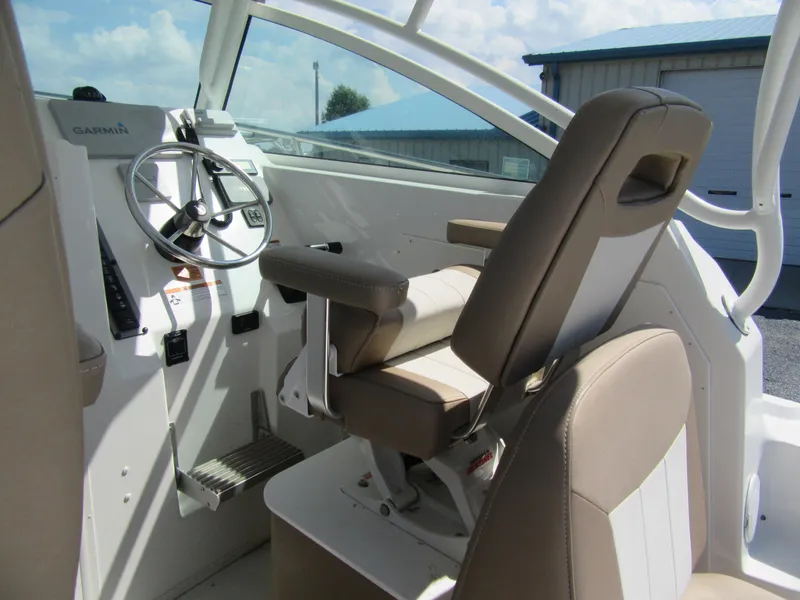 Slide: The Image of 2019 Parker 2810 XLD Walkaround boat cockpit with steering wheel and captain's chair. - 11