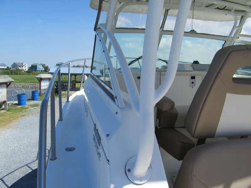 Slide: The Image of 2019 Parker 2810 XLD Walkaround boat, side view with seating and railings. - 13