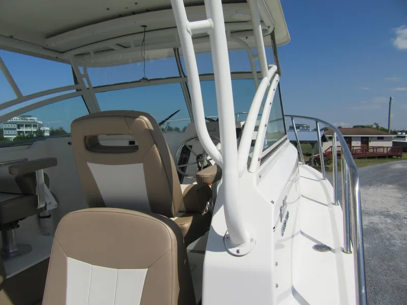 Slide: The Image of 2019 Parker 2810 XLD Walkaround boat interior with beige and white seating. - 14