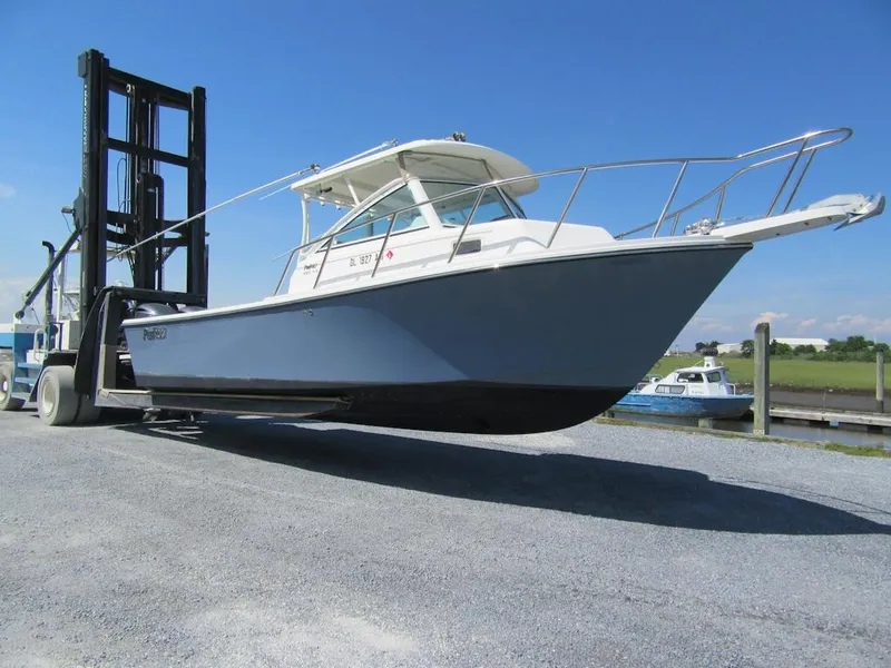 Slide: The Image of 2019 Parker 2810 XLD Walkaround boat on a forklift at a marina. - 2
