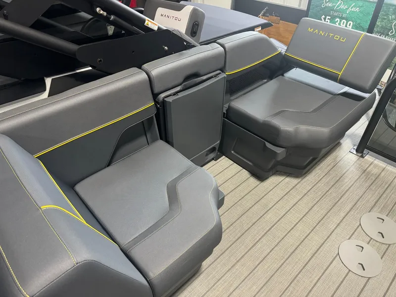 Slide: The Image of 2024 Manitou Explore boat interior with gray seating and yellow accents. - 10