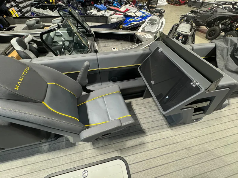 Slide: The Image of 2024 Manitou Explore boat interior with gray seating and yellow accents. - 12