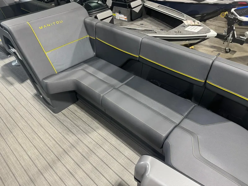 Slide: The Image of 2024 Manitou Explore boat interior with sleek gray seating and yellow accents. - 3
