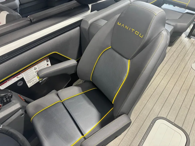 Slide: The Image of 2024 Manitou Explore boat seat with gray upholstery and yellow accents. - 7
