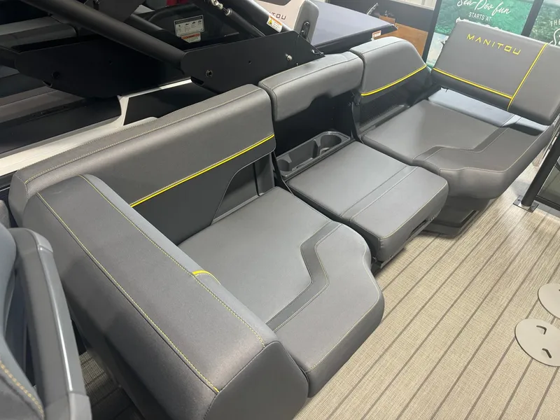 Slide: The Image of 2024 Manitou Explore boat interior with gray seating and yellow accents. - 8