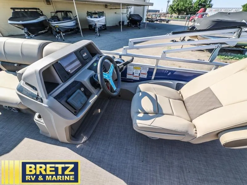 Slide: The Image of 2024 Fishin' Barge 22 DLX interior with steering console and seating at Bretz RV & Marine. - 10