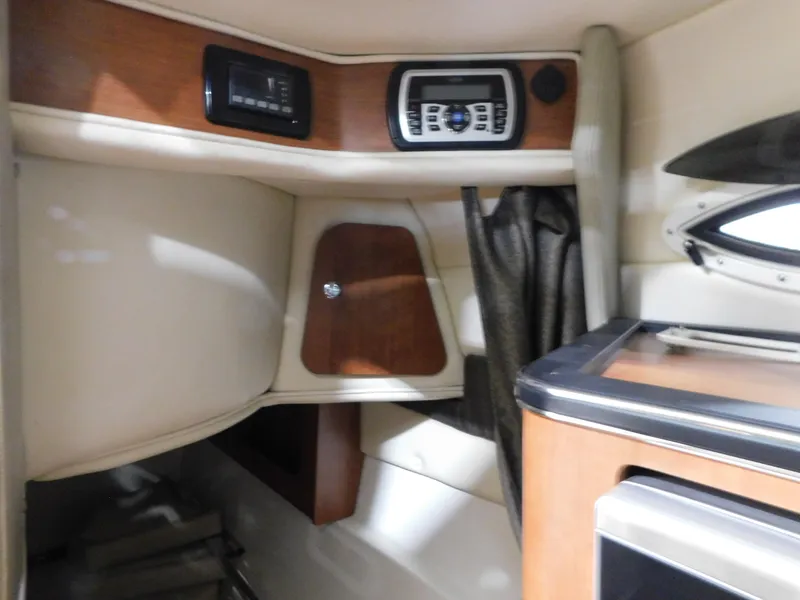 Slide: The Image of Interior of 2015 Stingray 250 CS boat with wood accents and control panel. - 15