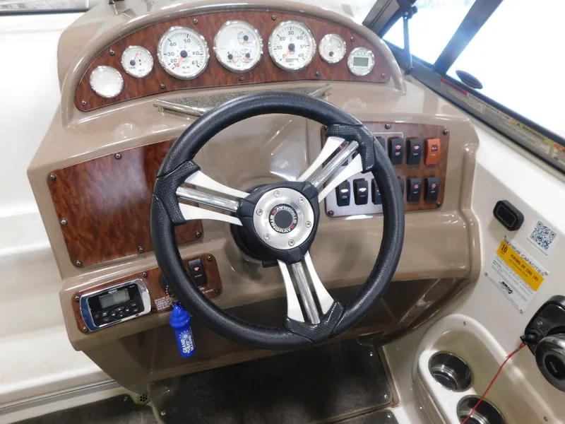 Slide: The Image of Dashboard of a 2015 Stingray 250 CS boat with steering wheel and gauges. - 18