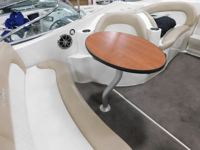 Slide: The Image of 2015 Stingray 250 CS boat interior with seating and wooden table. - 6