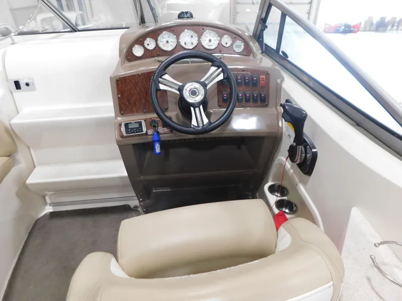 Slide: The Image of 2015 Stingray 250 CS boat cockpit with steering wheel, gauges, and controls. - 8