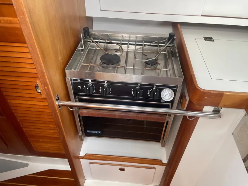 Slide: The Image of 1993 Freedom 35 yacht kitchen with a compact stainless steel stove and oven. - 10