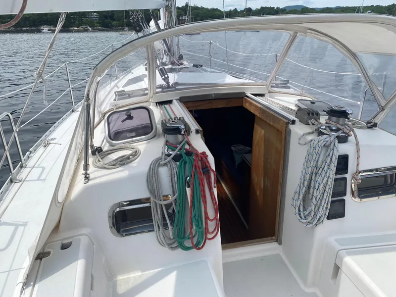 Slide: The Image of Sailboat cockpit of 1993 Freedom 35 with ropes and open cabin door. - 24