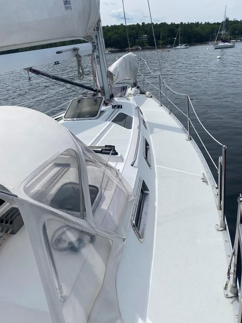 Slide: The Image of Sailboat Freedom 35, 1993 model, docked on calm water with visible deck and sails. - 25