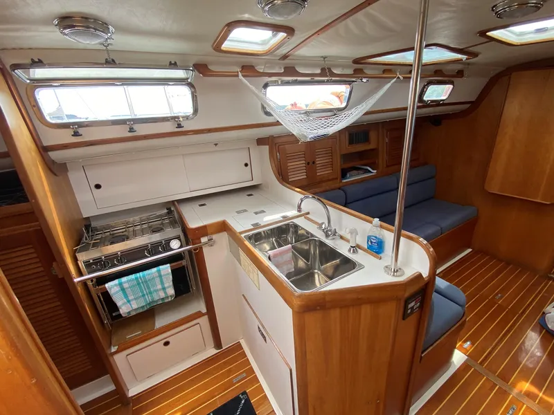 Slide: The Image of Interior of 1993 Freedom 35 sailboat with kitchen and seating area. - 26