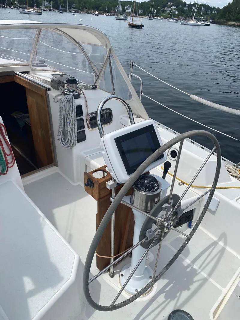 Slide: The Image of Cockpit of 1993 Freedom 35 sailboat with steering wheel and navigation equipment. - 27