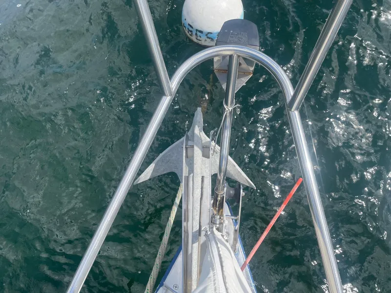 Slide: The Image of Bow view of 1993 Freedom 35 sailboat with anchor over clear water. - 30