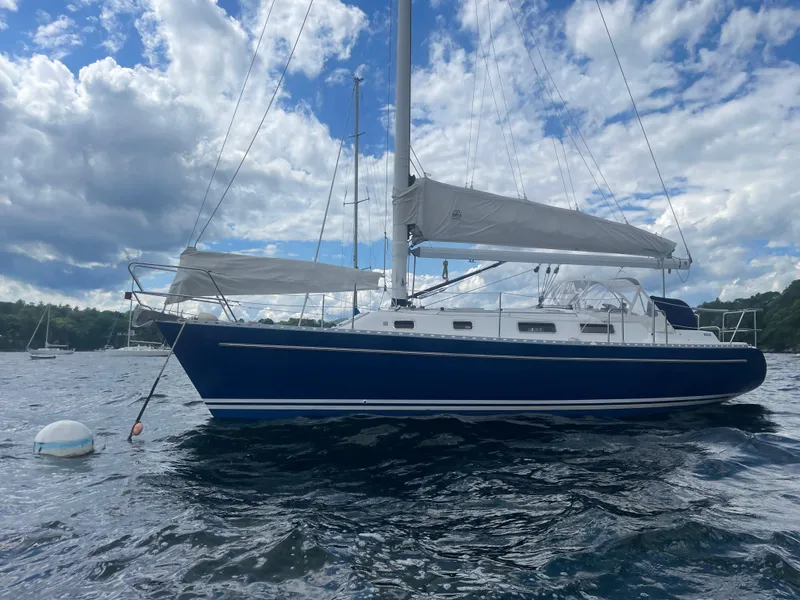 Slide: The Image of 1993 Freedom 35 sailboat on water under cloudy sky. - 6