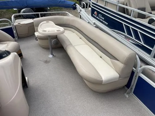 Slide: The Image of 2016 Sun Tracker Fishin' Barge 20 DLX interior with beige seating and table. - 7