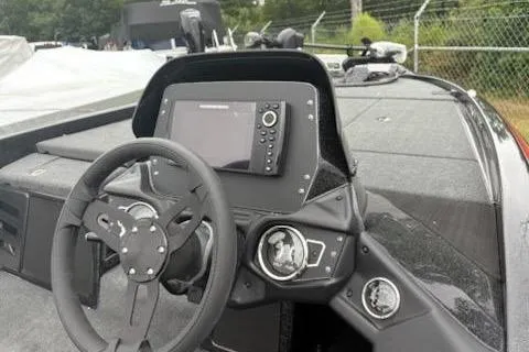 Slide: The Image of 2024 Skeeter ZX200 boat dashboard with steering wheel and navigation display. - 10