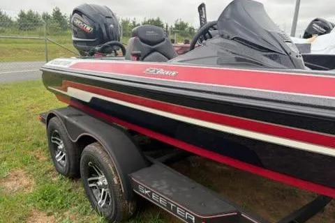 Slide: The Image of 2024 Skeeter ZX200 boat with red and black design on a trailer. - 11