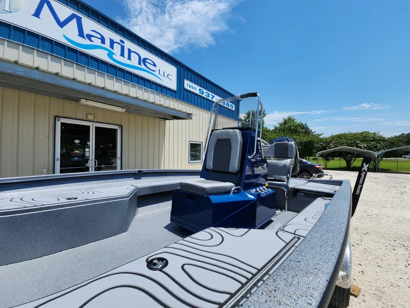 Slide: The Image of 2025 Xpress H20B boat displayed outside a marine dealership under a clear blue sky. - 10