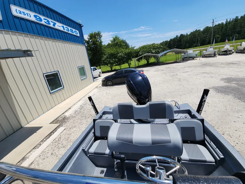 Slide: The Image of 2025 Xpress H20B boat parked outside a building on a sunny day. - 14