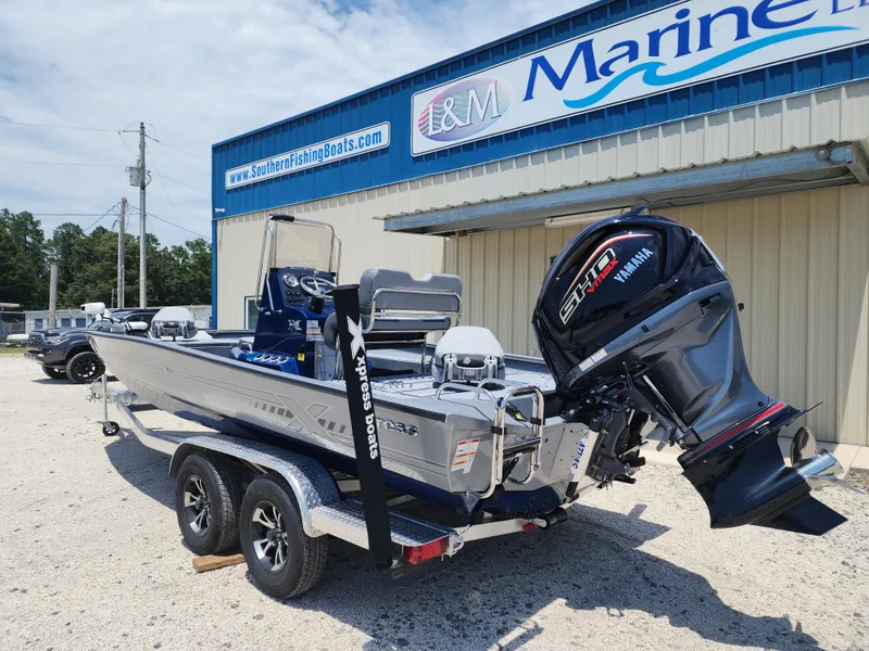 Slide: The Image of 2025 Xpress H20B boat with Yamaha engine at a marine dealership. - 4