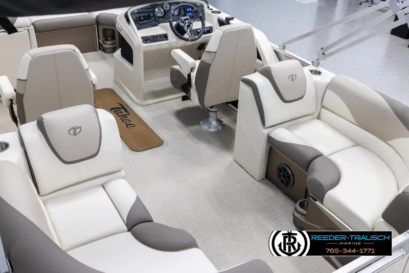Slide: The Image of 2024 Tahoe LTZ QL boat interior with beige and brown seating, steering console, and Reeder-Trausch Marine logo. - 11
