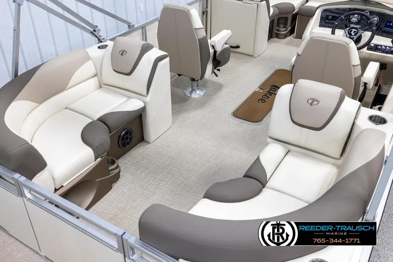 Slide: The Image of 2024 Tahoe LTZ QL boat interior with beige and gray seating, steering console, and carpeted floor. - 12