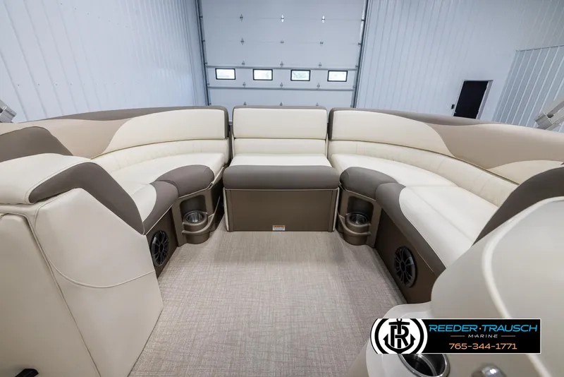 Slide: The Image of 2024 Tahoe LTZ QL boat interior with beige and brown seating, cup holders, and speakers. - 18