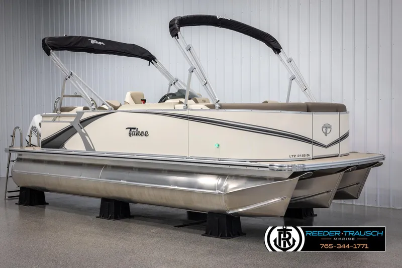 Slide: The Image of 2024 Tahoe LTZ QL pontoon boat with black canopy in showroom. - 2