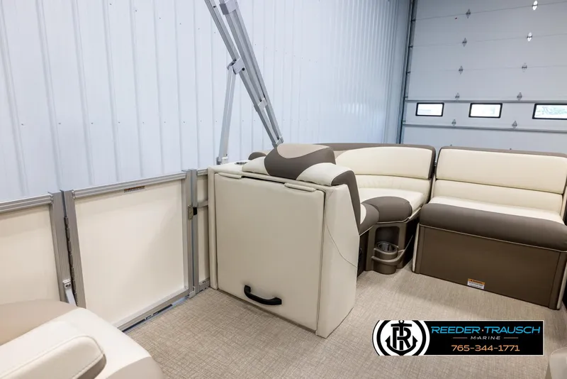 Slide: The Image of 2024 Tahoe LTZ QL boat interior with beige and brown seating, Reeder-Trausch Marine logo. - 21