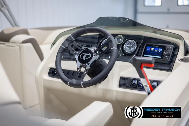 Slide: The Image of 2024 Tahoe LTZ QL boat dashboard with steering wheel and control panel. - 23