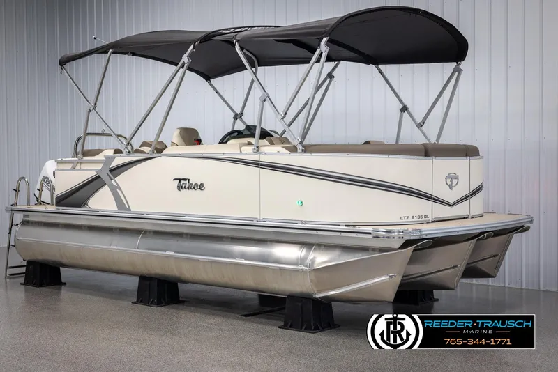 Slide: The Image of 2024 Tahoe LTZ QL pontoon boat with black canopy in showroom. - 3