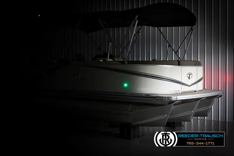 Slide: The Image of 2024 Tahoe LTZ QL pontoon boat in a dimly lit indoor storage. - 4