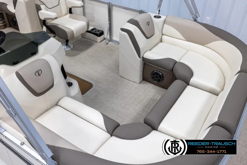 Slide: The Image of 2024 Tahoe LTZ QL boat interior with beige and brown seating, Reeder-Trausch Marine logo. - 9