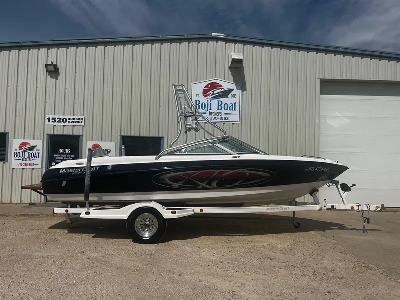 Slide: The Image of 2001 MasterCraft X-10 boat on trailer outside Boji Boat Brokers building. - 0