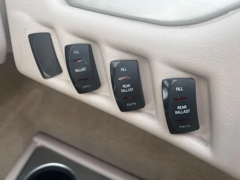 Slide: The Image of MasterCraft X-10 2001 boat ballast control switches for filling and emptying rear ballast. - 11