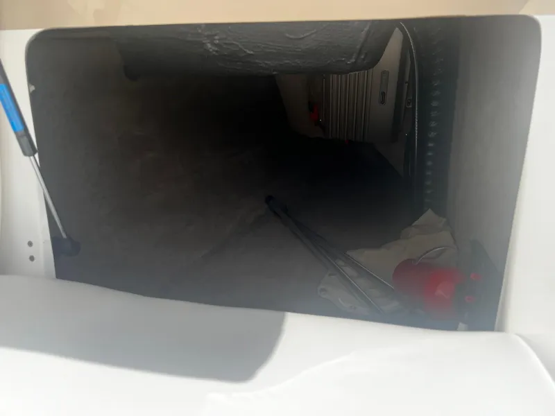 Slide: The Image of Storage compartment of a 2001 MasterCraft X-10 boat with equipment inside. - 13