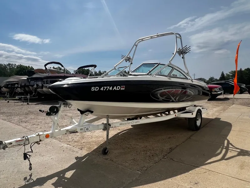 Slide: The Image of 2001 MasterCraft X-10 boat on trailer in outdoor dealership lot. - 2