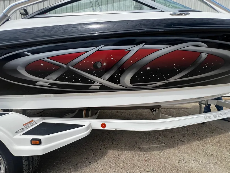 Slide: The Image of 2001 MasterCraft X-10 boat with custom graphics on trailer. - 24
