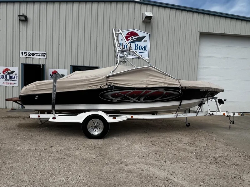Slide: The Image of 2001 MasterCraft X-10 boat on trailer, covered, outside Boji Boat Brokers. - 28