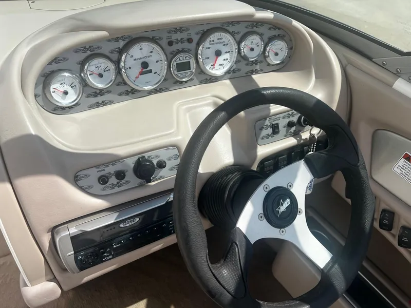 Slide: The Image of 2001 MasterCraft X-10 boat dashboard with steering wheel and instrument panel. - 7