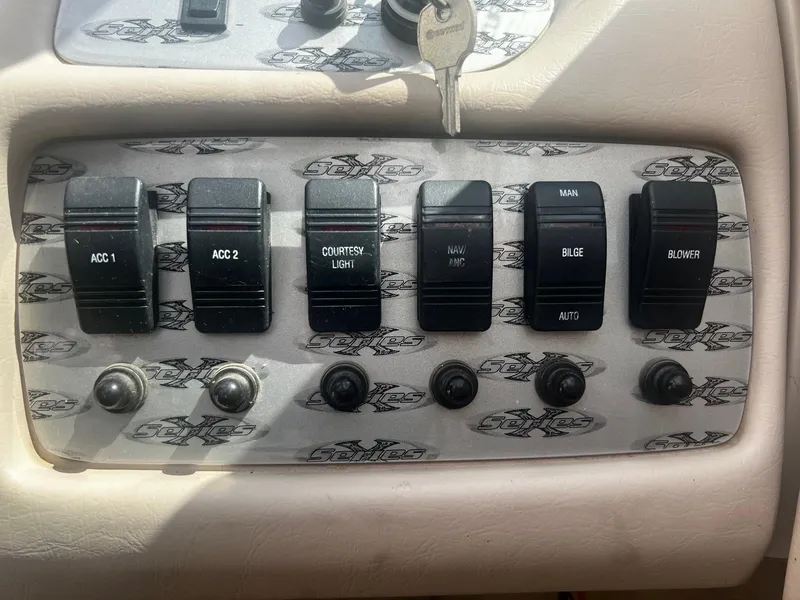 Slide: The Image of Control panel of a 2001 MasterCraft X-10 boat with various switches. - 9