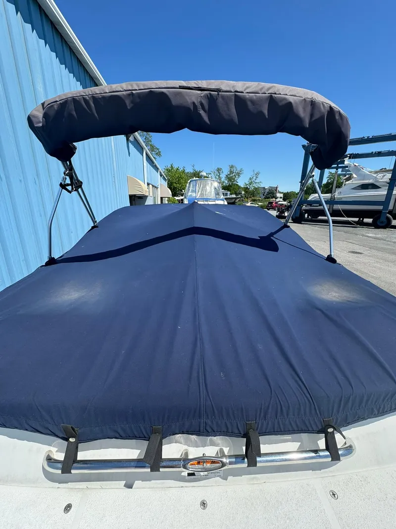 Slide: The Image of 2004 Four Winns 200 Horizon boat with blue cover and bimini top. - 5