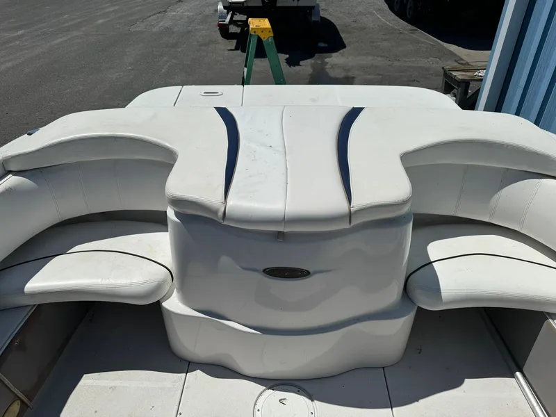 Slide: The Image of 2004 Four Winns 200 Horizon boat interior with white seating and storage compartments. - 6