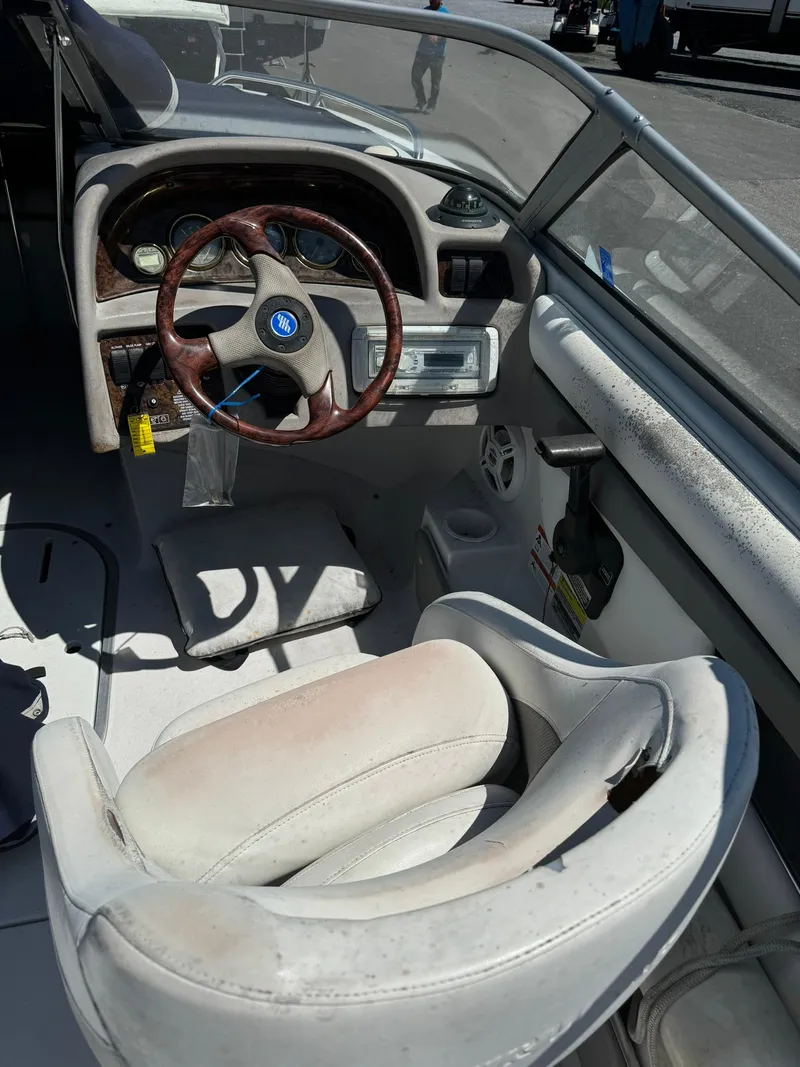 Slide: The Image of 2004 Four Winns 200 Horizon boat interior with steering wheel and dashboard. - 8
