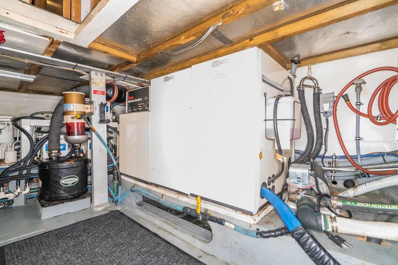 Slide: The Image of Engine room of a 1996 Hatteras 70 Sport Deck Motor Yacht with generator and equipment. - 10